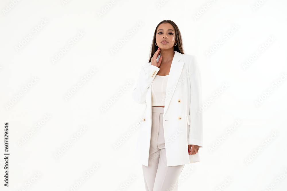 Young elegant woman in trendy fashionable clothes posing in studio, looking at the camera. Young elegant woman in trendy fashionable clothes posing in studio, looking at the camera.
