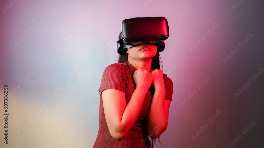 Young Asian Indian woman scared, wearing virtual reality headset, a frightened girl with VR glasses concept studio portrait Young Asian Indian woman scared, wearing virtual reality headset, a frightened girl with VR glasses concept studio portrait