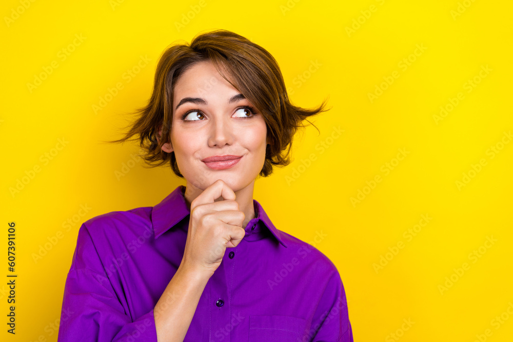 Photo of cute lady have startup idea look side empty space arm on chin wear violet office blouse isolated yellow color background Photo of cute lady have startup idea look side empty space arm on chin wear violet office blouse isolated yellow color background