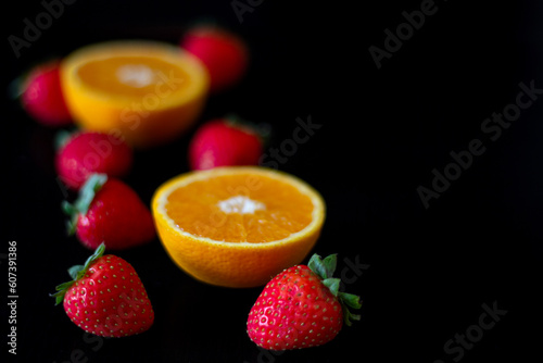Strawberry  apple  cut orange shot on a dark background. space for text