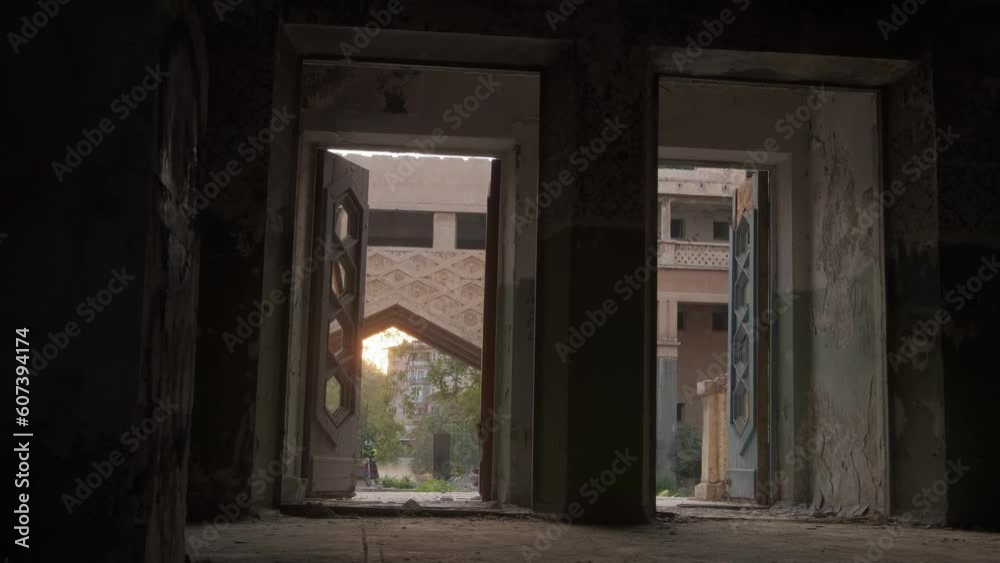 Two bikers on sports bikes and protective suits drive into a dark old building Two bikers on sports bikes and protective suits drive into a dark old building