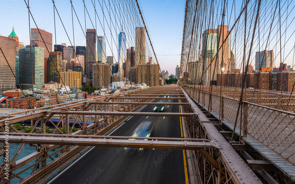 Fototapeta premium Moving cars on the Brooklyn Bridge in the New York City in the morning dawn.
