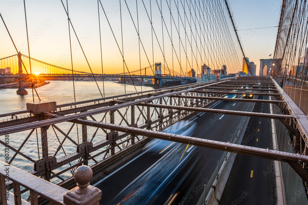 A rising sun about the Manhattan Bridge and the Brooklyn Bridge full of traffic. A rising sun about the Manhattan Bridge and the Brooklyn Bridge full of traffic.