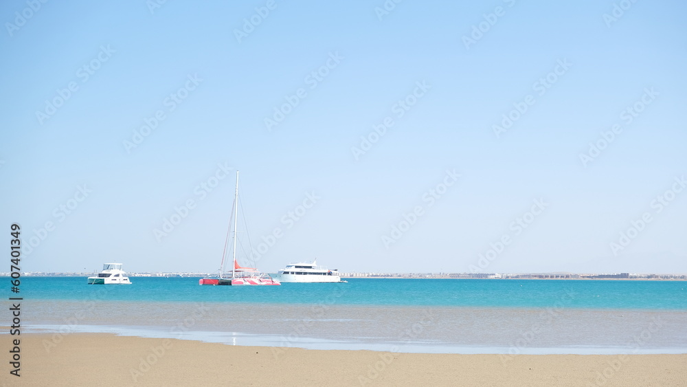 Serenity Unveiled: A Mesmerizing Sunset at Sea with Graceful Boats Amidst the Golden Hues, an Enchanting Moment of Tranquility and Nautical Beauty in Hurghada , El gouna , Egypt 