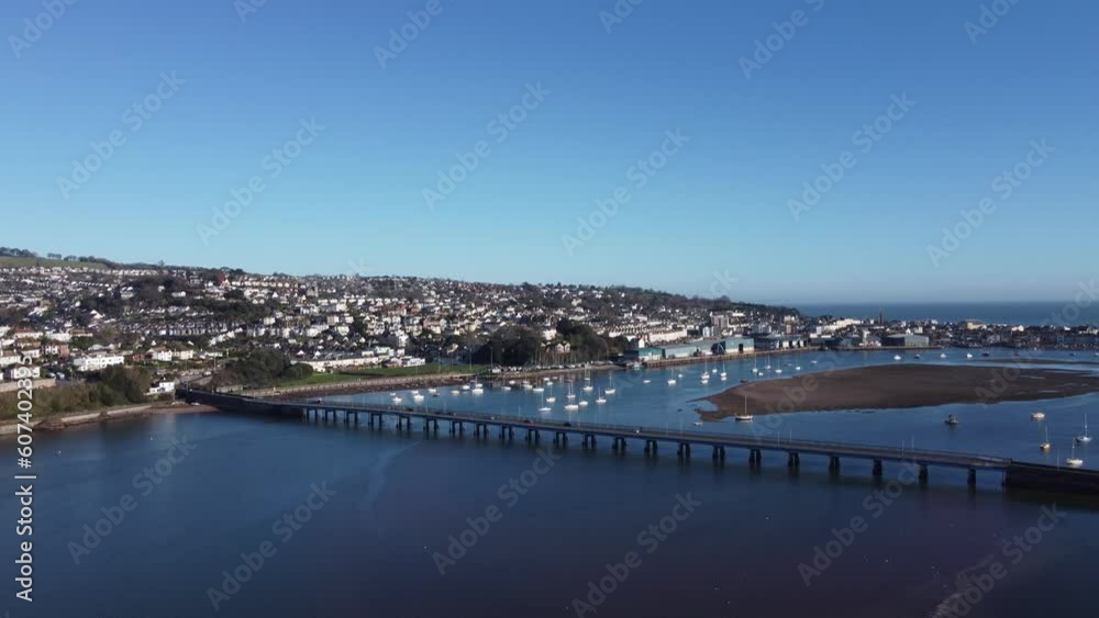 Teignmouth, South Devon, England: DRONE AERIAL VIEWS: The drone flies towards the River Teign bridge, Teignmouth Docks and the seaside town of Teignmouth (Clip 3). Teignmouth, South Devon, England: DRONE AERIAL VIEWS: The drone flies towards the River Teign bridge, Teignmouth Docks and the seaside town of Teignmouth (Clip 3).