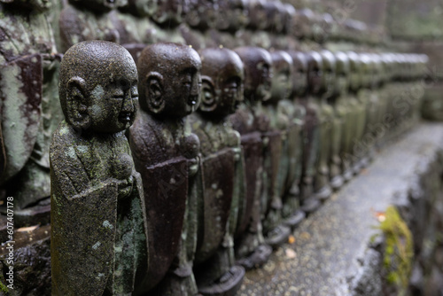 stone statues of Ksitigarbha bodhisattva (Jizo) at Hasedera Temple, Kamakura, Japan on a rainy day photo