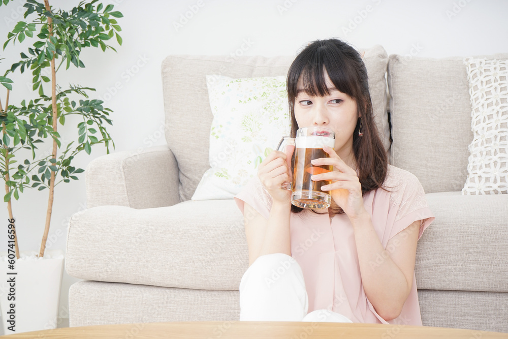 自宅でビールを飲む若い女性 自宅でビールを飲む若い女性