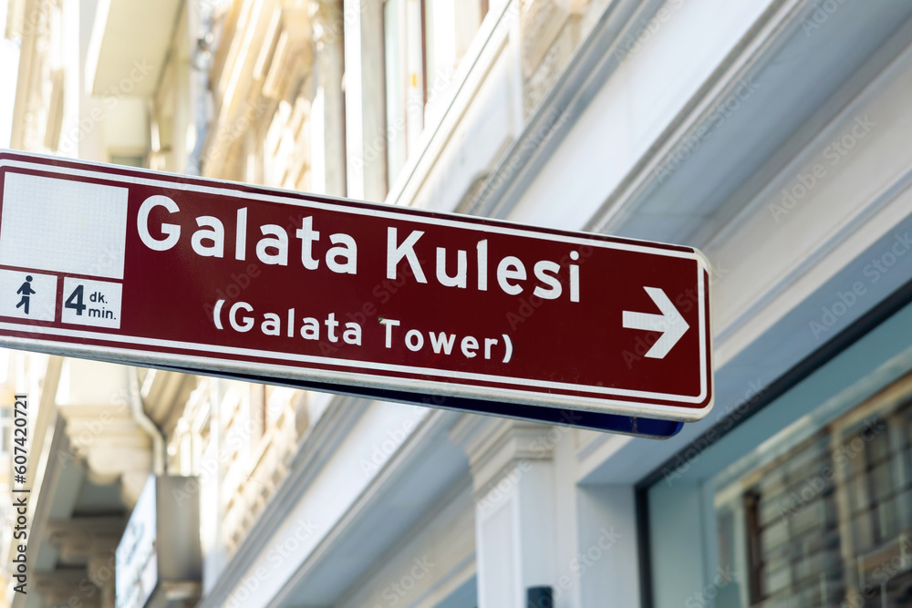 Fototapeta premium Galata Tower direction sign in Istanbul City, Turkey (Turkiye). Defocused city background