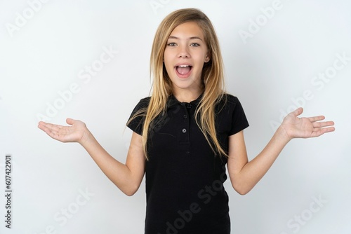 beautiful teen girl wearing black dress over white studio background celebrating crazy and amazed for success with arms raised and open eyes screaming excited. Winner concept photo