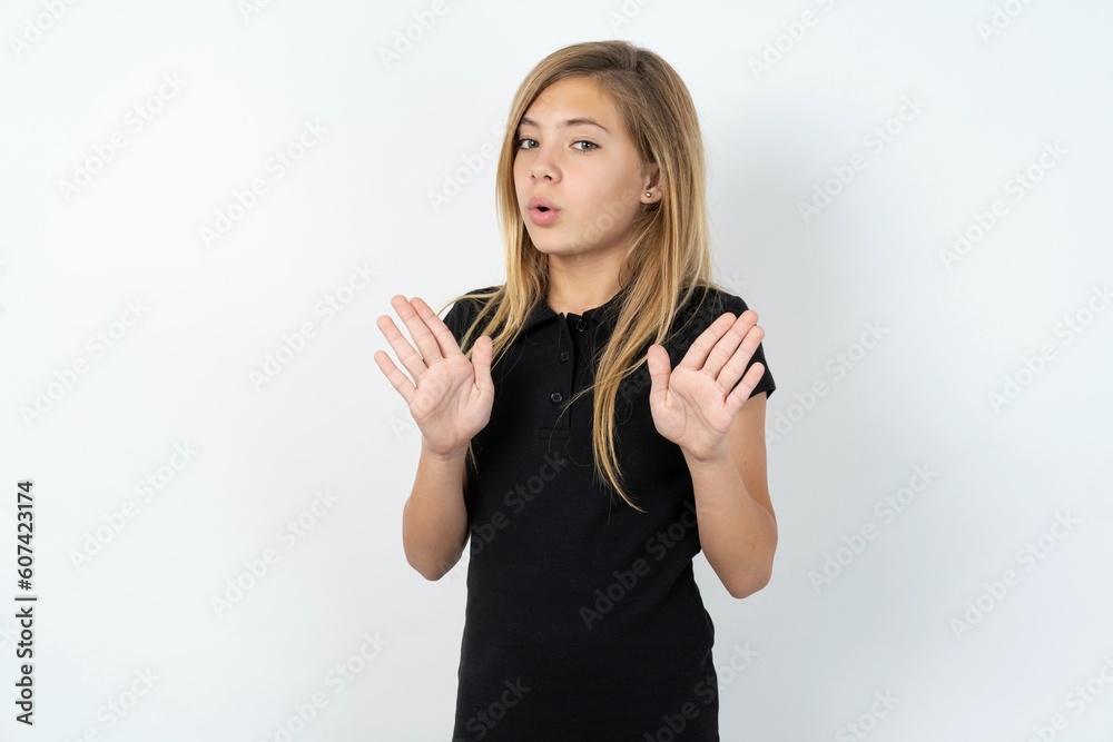 beautiful teen girl wearing black dress over white studio background Moving away hands palms showing refusal and denial with afraid and disgusting expression. Stop and forbidden. beautiful teen girl wearing black dress over white studio background Moving away hands palms showing refusal and denial with afraid and disgusting expression. Stop and forbidden.