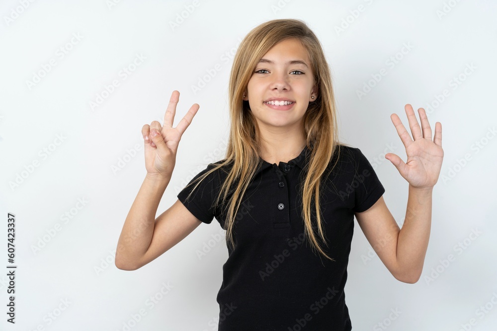 beautiful teen girl wearing black dress over white studio background showing and pointing up with fingers number seven while smiling confident and happy. beautiful teen girl wearing black dress over white studio background showing and pointing up with fingers number seven while smiling confident and happy.