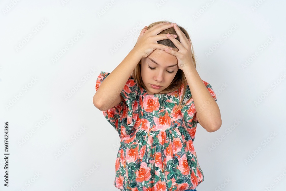 beautiful teen girl wearing flowered dress over white studio background suffering from strong headache desperate and stressed because of overwork. Depression and pain concept. beautiful teen girl wearing flowered dress over white studio background suffering from strong headache desperate and stressed because of overwork. Depression and pain concept.