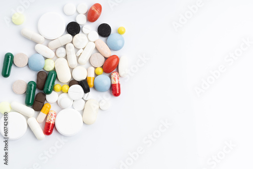 Pack of pills and different pills and capsules on a white background with space for text