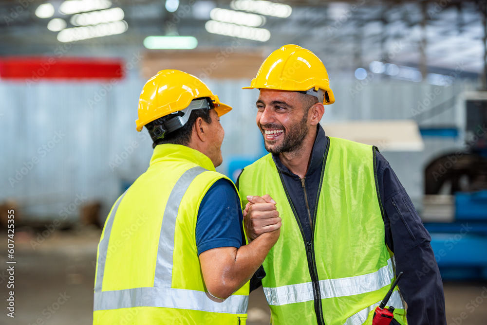 greeting by handshake touch fist and elbow of two engineer supervisor partnership in old factory. foreman greeting friend for good friendship colleague laborer in teamwork factory. greeting by handshake touch fist and elbow of two engineer supervisor partnership in old factory. foreman greeting friend for good friendship colleague laborer in teamwork factory.