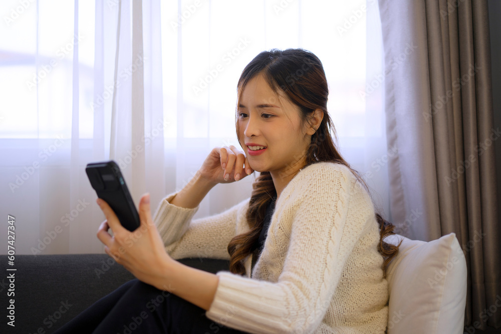 Pretty woman use smart phone at home. Happiness mood. Pretty woman use smart phone at home. Happiness mood.