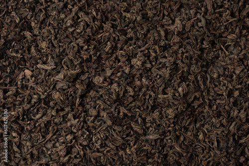Dried tea leaves as a background.