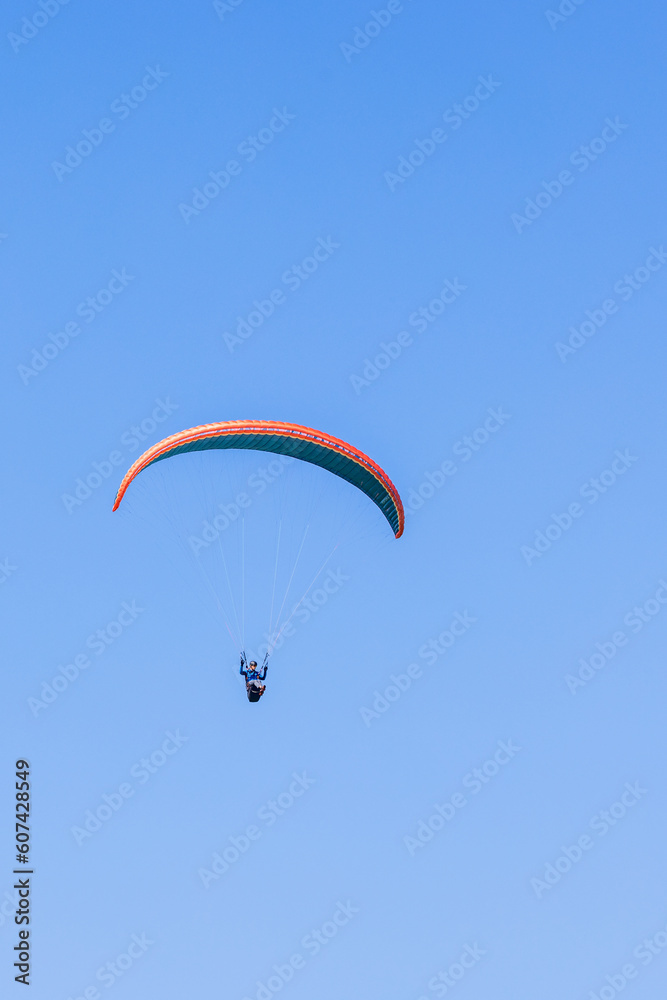 Paraglider flying at a blue sky Paraglider flying at a blue sky