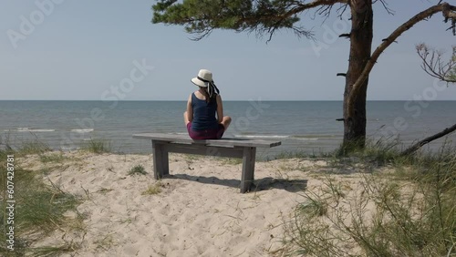 woman sitting on bench at latvian baltic sea