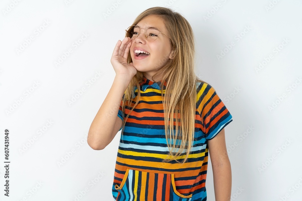 beautiful caucasian teen girl wearing striped T-shirt over white wall profile view, looking happy and excited, shouting and calling to copy space. beautiful caucasian teen girl wearing striped T-shirt over white wall profile view, looking happy and excited, shouting and calling to copy space.
