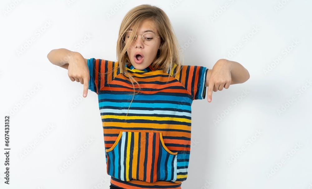 Amazed beautiful caucasian teen girl wearing striped T-shirt over white ...