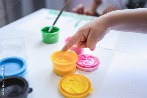 Finger painting. Close-up. Fingers of children s hands in bright paint. Early development. Hobby