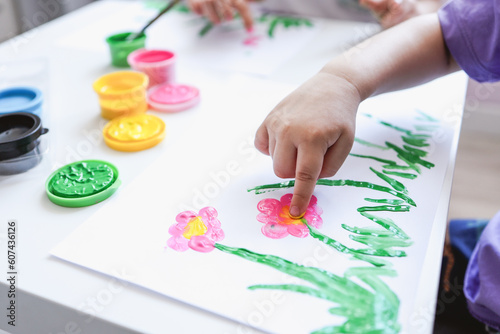 Finger painting. Close-up. Fingers of children's hands in bright paint. Early development. Hobby