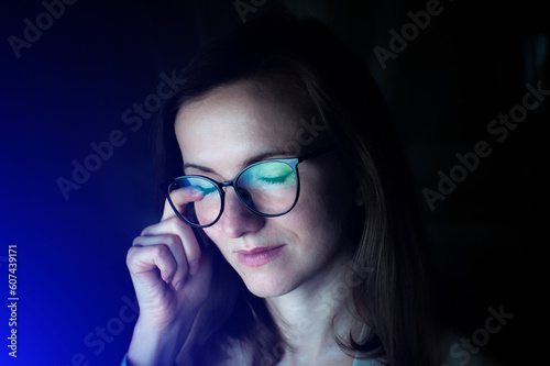 Tired business woman in glasses is working online at the laptop or computer. Social media influencer creating content. Programmer or designer work. Marketing and stock market.