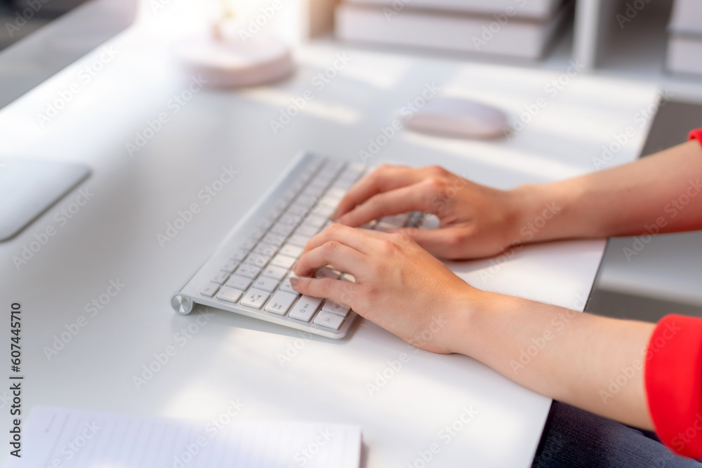 Close-up of hand of businesswoman working using laptop computer to record and print information for a marketing plan analyze the balance sheet report quarterly financial statement. Close-up of hand of businesswoman working using laptop computer to record and print information for a marketing plan analyze the balance sheet report quarterly financial statement.