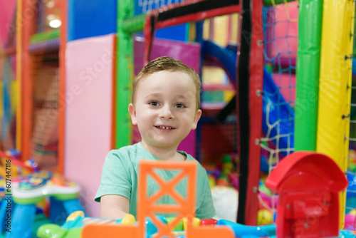 Child on the playground with colored plastic balls photo