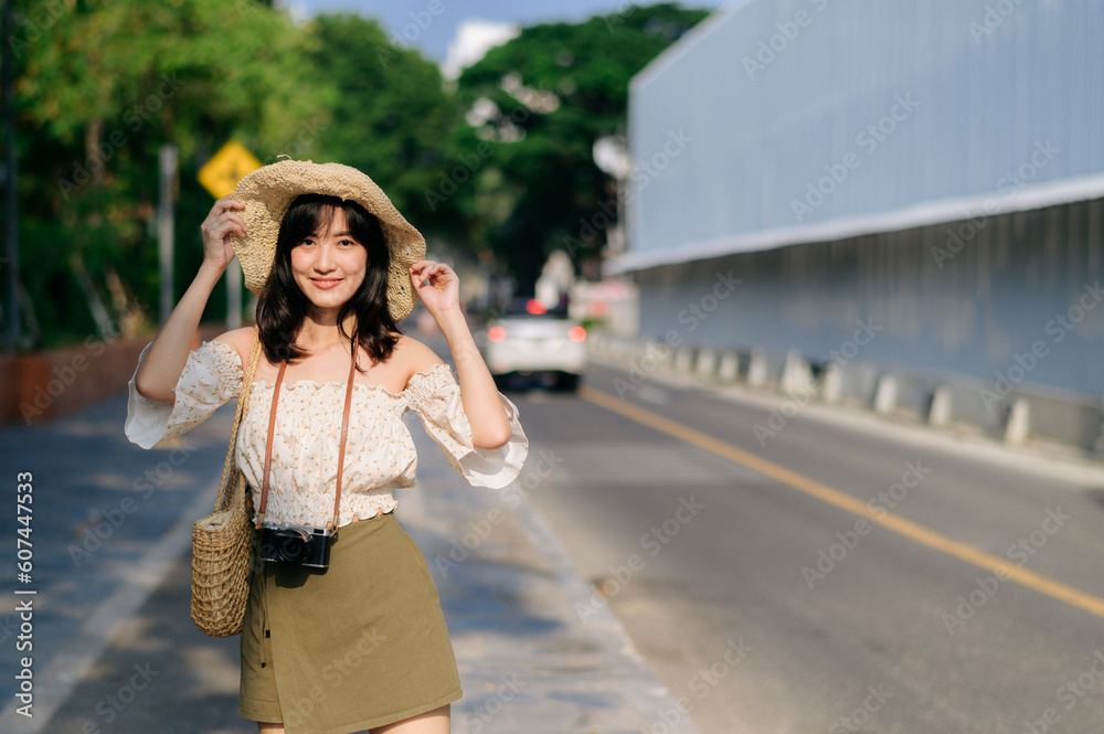 Portrait of asian young woman traveler with weaving hat and basket and a camera on green public park nature background. Journey trip lifestyle, world travel explorer or Asia summer tourism concept. Portrait of asian young woman traveler with weaving hat and basket and a camera on green public park nature background. Journey trip lifestyle, world travel explorer or Asia summer tourism concept.