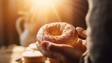 Hand holding donut, indulging in unhealthy refreshment generated by AI
