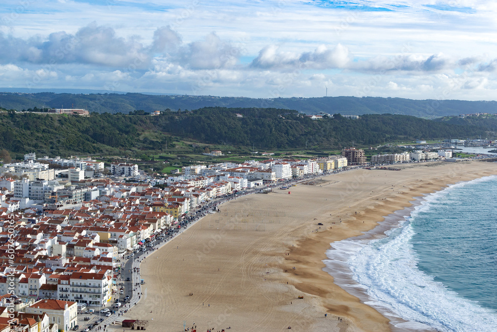 The city of Nazare in Portugal, the symbol of surfing. Coastline and view from above on the town. Tourist place with big waves.