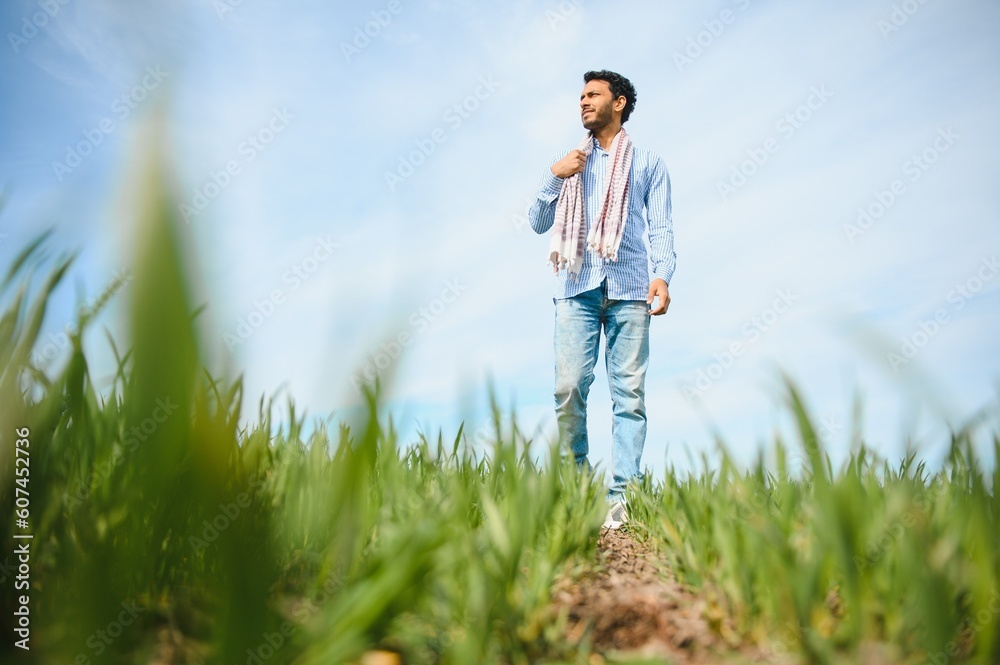 worry less ,indian farmer standing in his healthy wheat field worry less ,indian farmer standing in his healthy wheat field