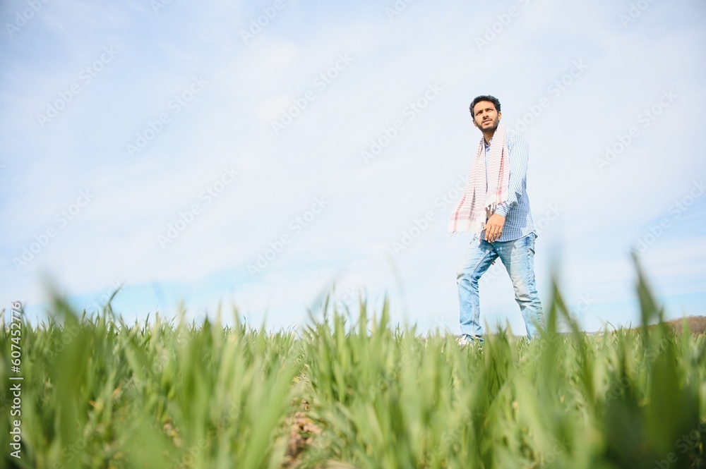 worry less ,indian farmer standing in his healthy wheat field worry less ,indian farmer standing in his healthy wheat field