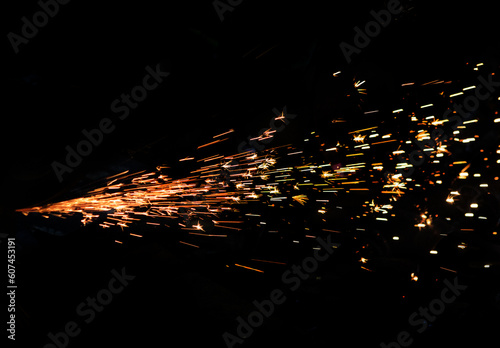 sparks of metal against dark background