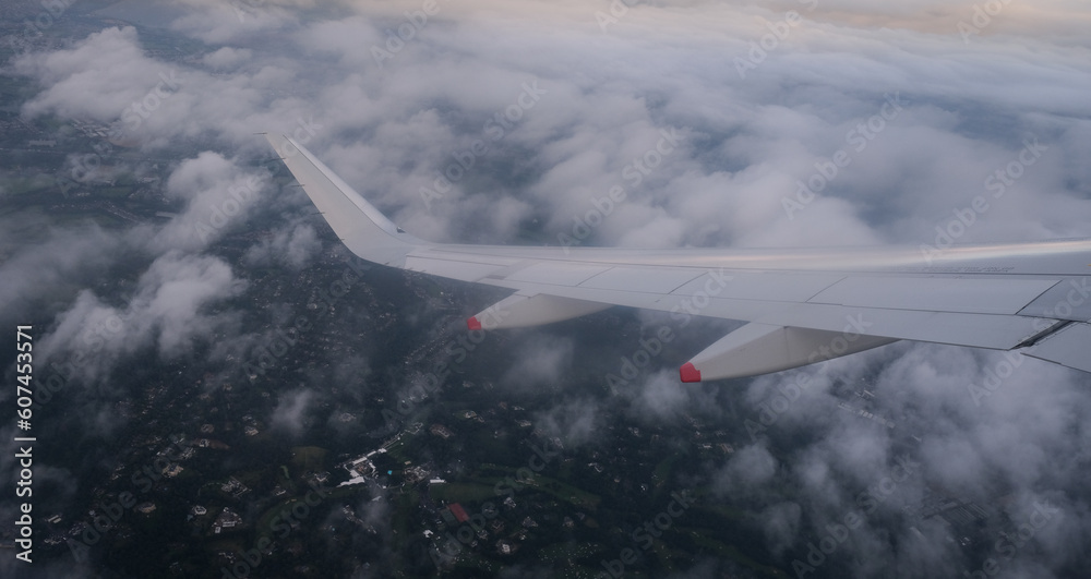 Fototapeta premium Plane in flight above London city united Kingdom. Aerial top view from air wing plane window