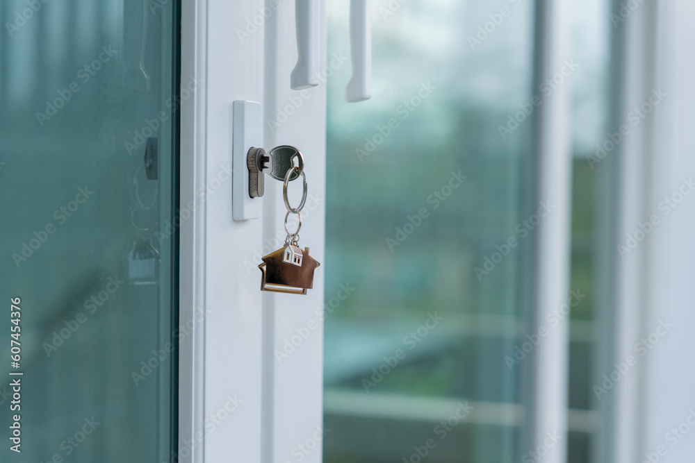 Landlord key for unlocking house is plugged into the door. Second hand house for rent and sale. keychain is blowing in the wind. mortgage for new home, buy, sell, renovate, investment, owner, estate Landlord key for unlocking house is plugged into the door. Second hand house for rent and sale. keychain is blowing in the wind. mortgage for new home, buy, sell, renovate, investment, owner, estate