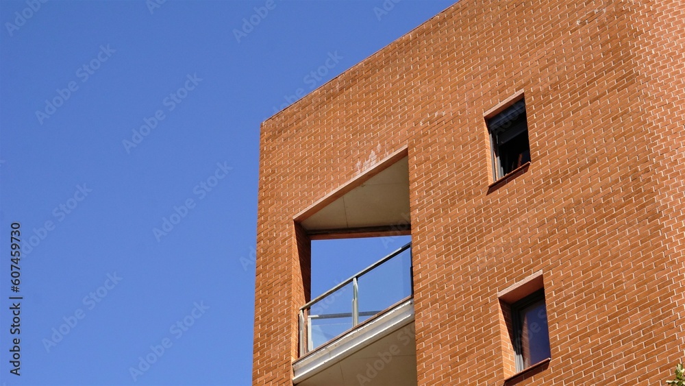 facade with brick balcony against the sky
