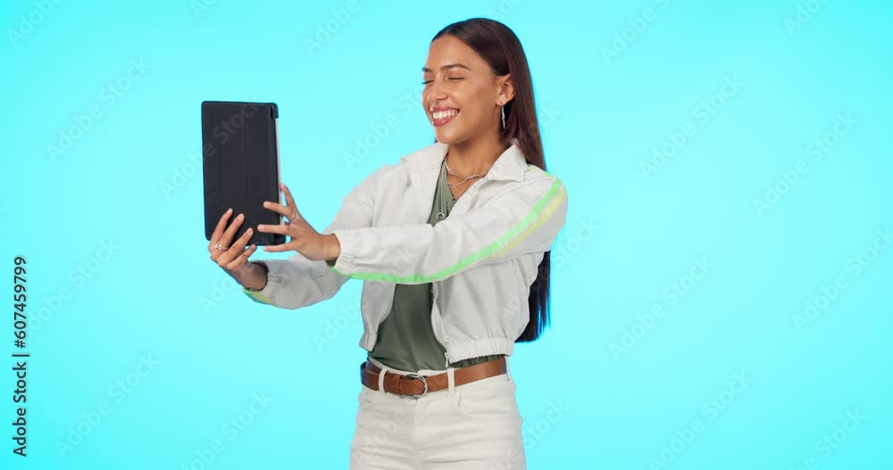 Technology, woman with tablet and video call against a blue background. Online communication or connectivity, social media or networking and female person on a hello gesture against a studio backdrop