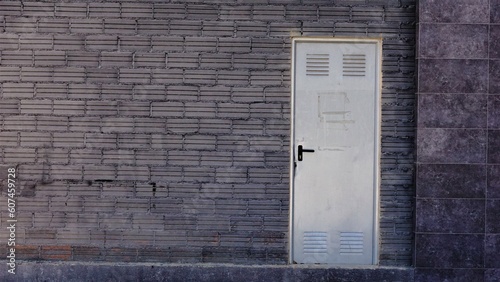 metal storage door in dark brick wall