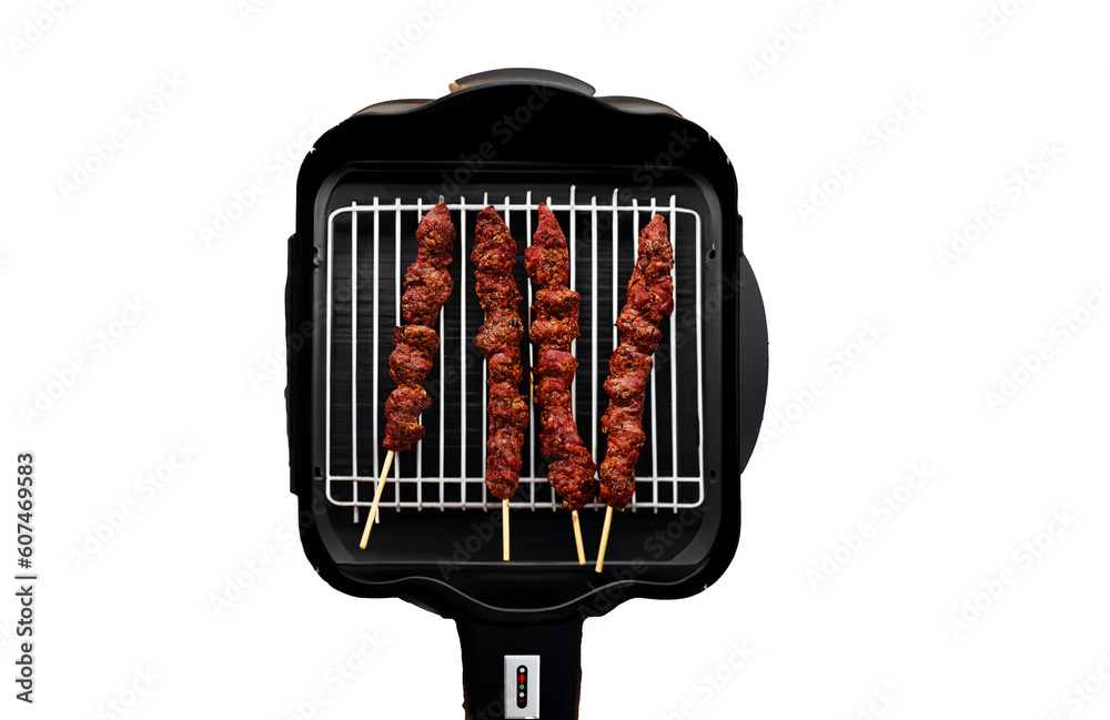 Electric grill widely used in Brazil, with roasting meat skewers. Barbecue top view. Electric grill widely used in Brazil, with roasting meat skewers. Barbecue top view.