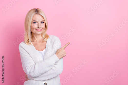 Portrait of pretty lady indicate finger empty space proposition isolated on pink color background