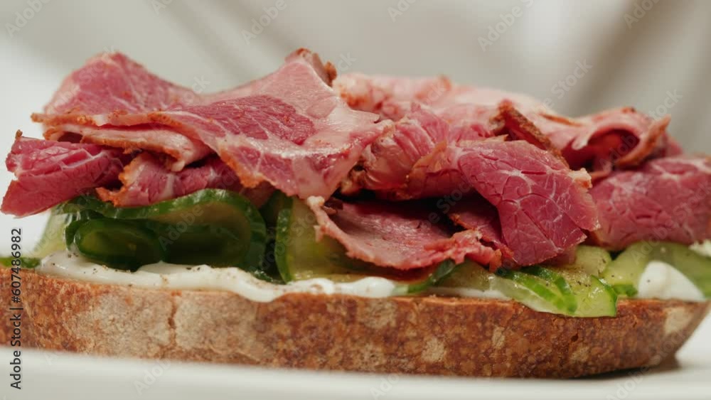American pastrami sandwich in New York ham meet cuts. chef cooking Famous thick cut sous vide beef sandwich on restaurant cafe kitchen. American pastrami sandwich in New York ham meet cuts. chef cooking Famous thick cut sous vide beef sandwich on restaurant cafe kitchen.