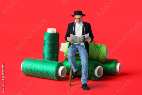 Sewing threads on red backg...