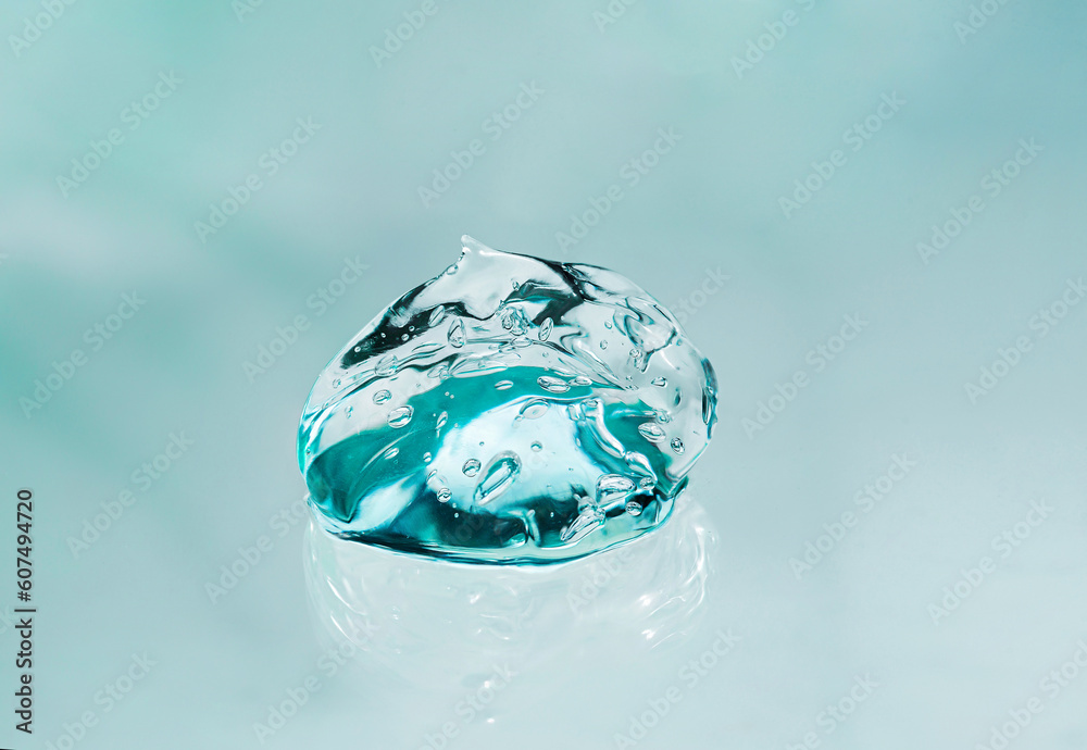 Collagen gel with bubble texture, close-up of transparent smear, blue background