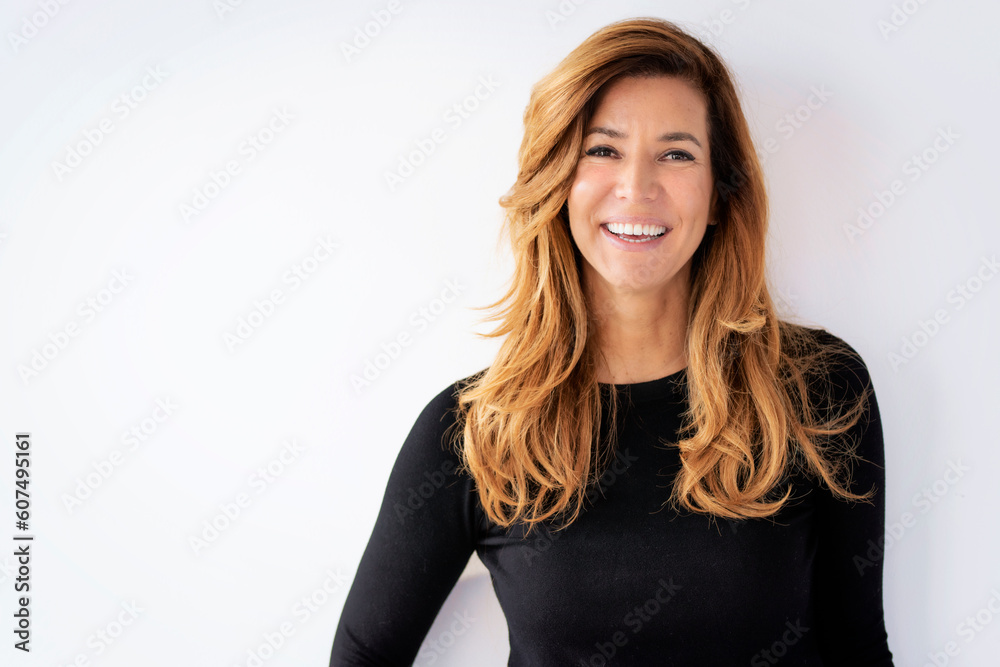 Portrait of beautiful mid aged woman with blond hair smiling against at isolated background Portrait of beautiful mid aged woman with blond hair smiling against at isolated background