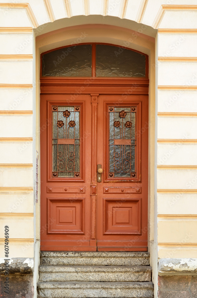 View of old building with wooden door and steps View of old building with wooden door and steps