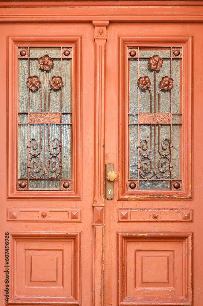 View of ornate wooden door in city, closeup View of ornate wooden door in city, closeup