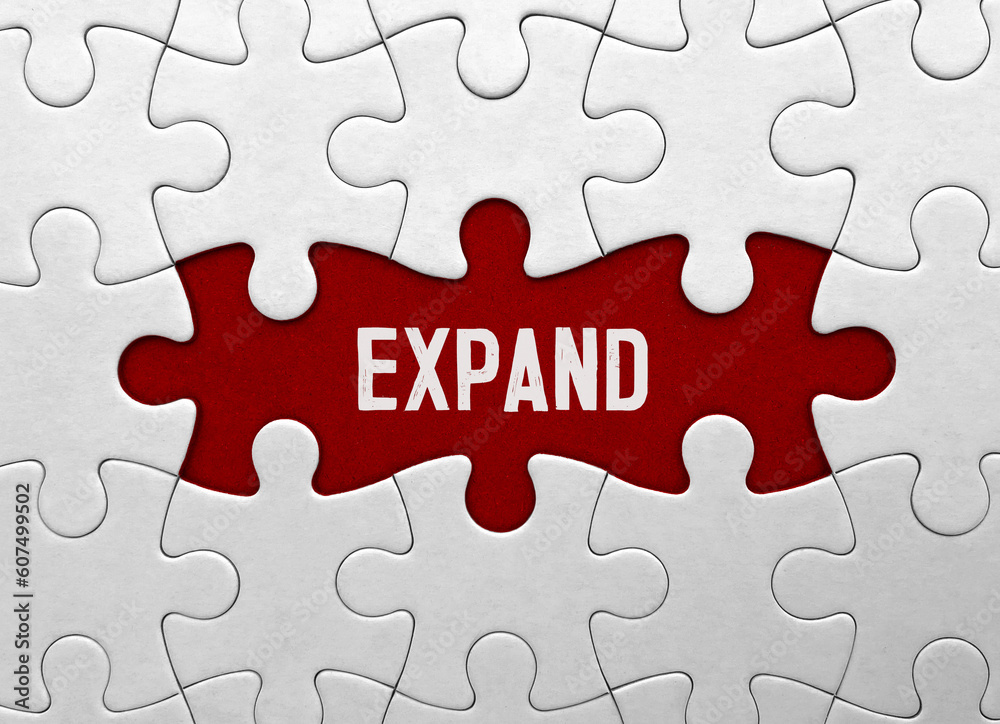 Word expand on red puzzle background Word expand on red puzzle background