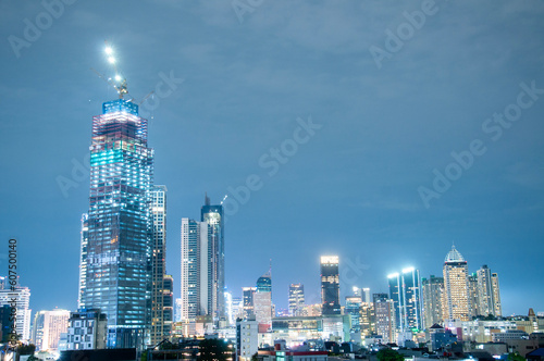 Jakarta's urban cityscape in the night time, so many buildings yet the constroction keeps developing